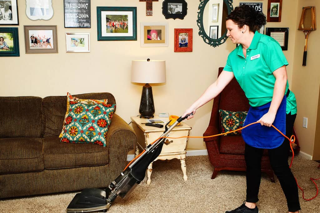 woman cleaning carpet in Indianapolis home